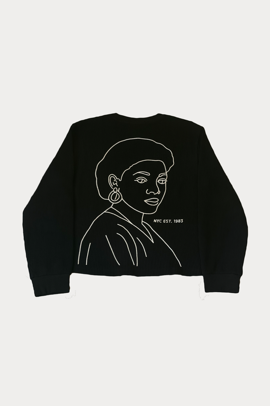 Back view of the La Cara Thermal Long Sleeve featuring a large cream chain-stitched portrait graphic on black organic waffle knit