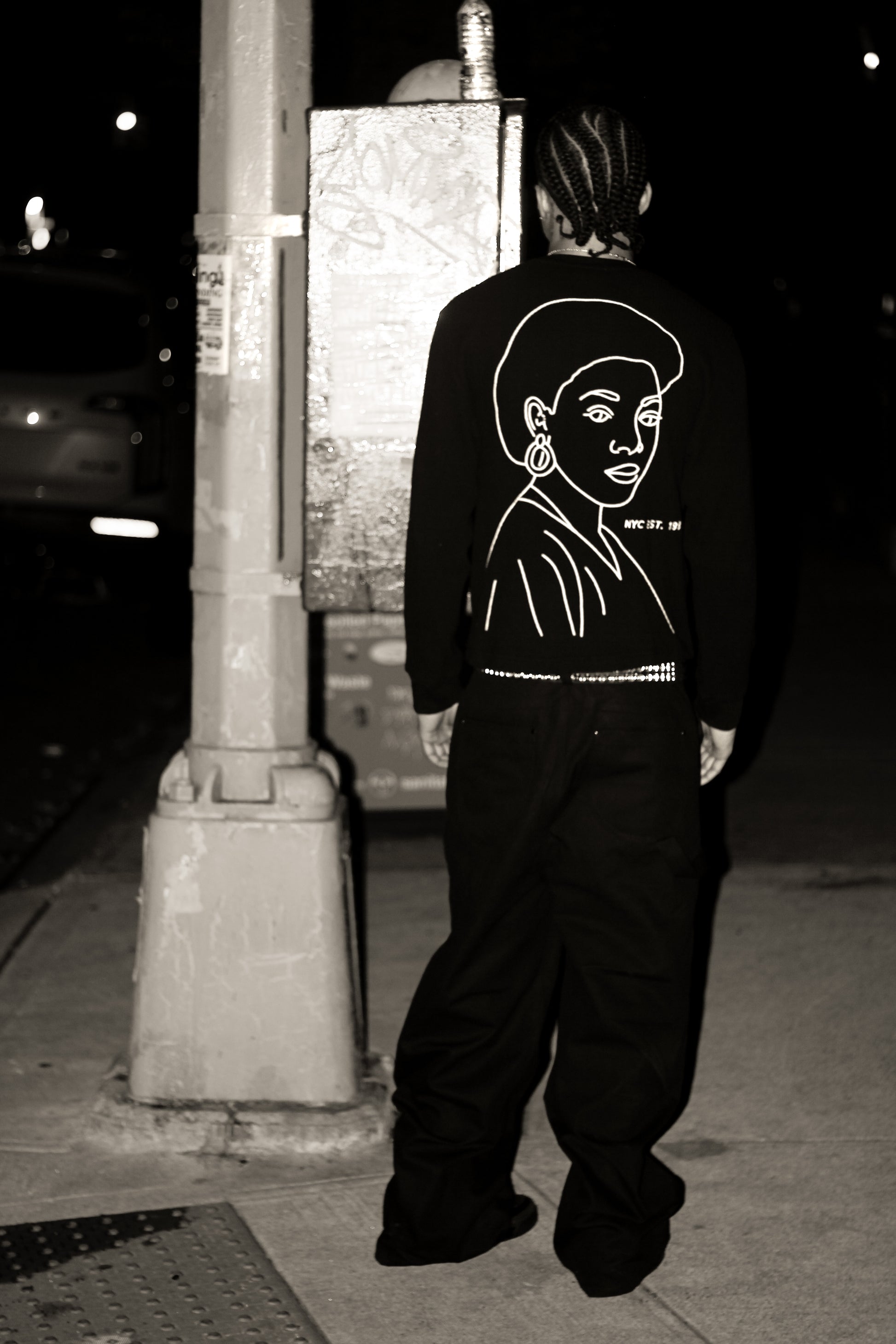 Model wearing the La Cara Thermal Long Sleeve, an embroidered long sleeve shirt with a chain-stitched portrait graphic on the back