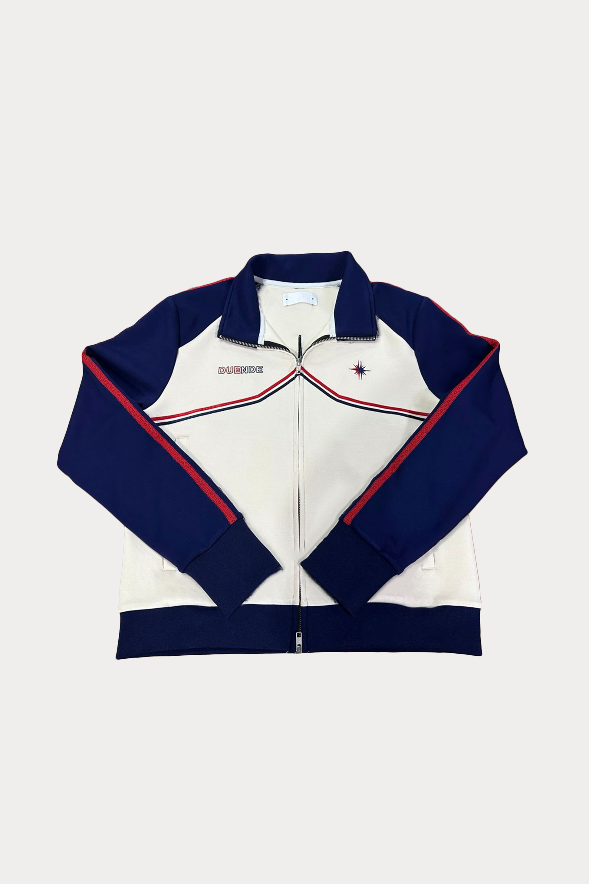 Vidrieras Track Jacket Front – premium track jacket and tracksuit jacket style design featuring navy sleeves, cream body, and embroidered DUENDE detailing, perfect as a modern jacket track silhouette