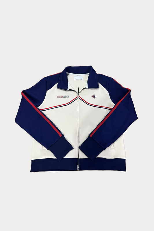 Vidrieras Track Jacket Front – premium track jacket and tracksuit jacket style design featuring navy sleeves, cream body, and embroidered DUENDE detailing, perfect as a modern jacket track silhouette